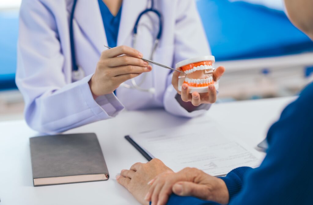 A dentist reviews a tooth extraction with their patient and provides aftercare instructions.