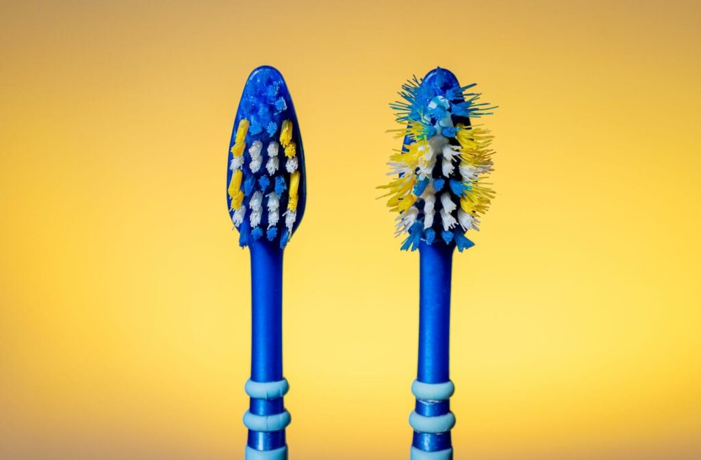 Brand new and frayed toothbrush heads next to each other.